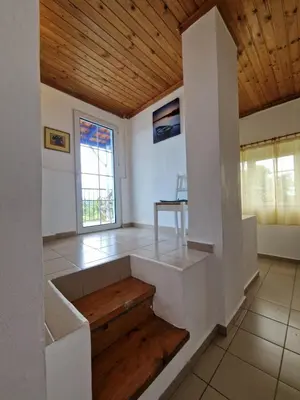a room with white walls and a wooden ceiling at Stefanos Garden in Arménoi
