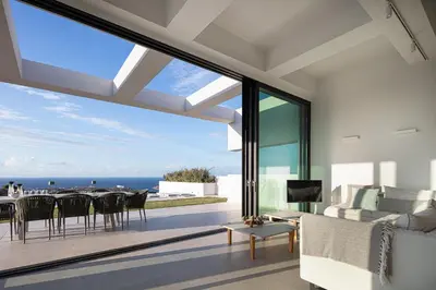 a living room with a view of the ocean at Blue Olive Luxury Villa in Kounoupidhianá