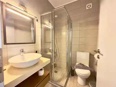 a bathroom with a sink and a shower and a toilet at Villa Eleni, Vamos Sea & Mountain View with Pool in Chania
