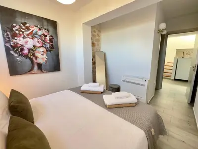 a bedroom with a bed and a painting on the wall at Villa Eleni, Vamos Sea & Mountain View with Pool in Chania