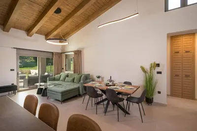 a living room with a table and a couch at Villa JOY in Módhion