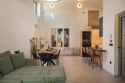 a living room with a couch and a table and chairs at Villa JOY in Módhion