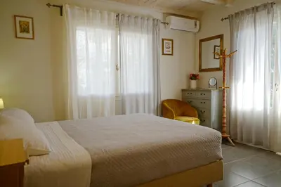 a bedroom with a bed and a dresser and a window at Seaside Cottage in Kato Daratso