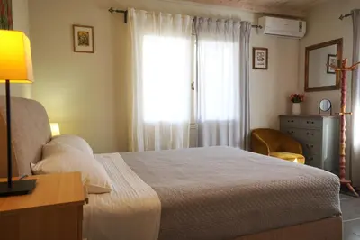 a bedroom with a bed and a window and a dresser at Seaside Cottage in Kato Daratso