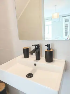a bathroom sink with two cups on top of it at Casa di Rosa in Chania Town
