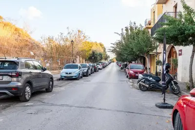 a street with cars parked on the side of the road at Dreamscape Residences - Zephi Suite in Chania Town