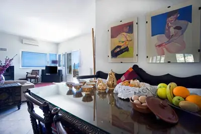 a living room with a table with fruits on it at Penthhouse next to the beach in Souda