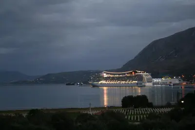 a large cruise ship in a large body of water at Penthhouse next to the beach in Souda