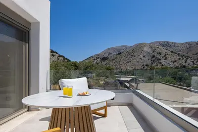 a table and chairs on a balcony with a view at Imbros Villas I 