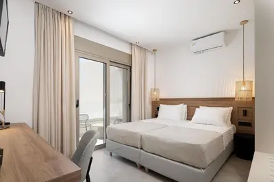 a bedroom with a bed and a table and a desk at Imbros Villas I 