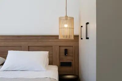 a bedroom with a bed and a pendant light at Imbros Villas I 