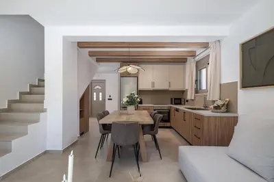 a kitchen and dining room with a table and chairs at Imbros Villas I 