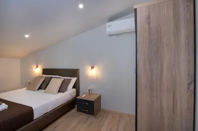 a bedroom with a bed and a sliding glass door at Casa di Mina's in Chania in Sirílion