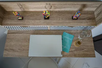 a table with a desk with a laptop and glasses at Tessera Alfa city apartment in Chania Town