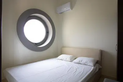 a bedroom with a bed with a round window at Modern Interior Villa in Chania Town