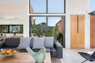 a living room with a couch and a bowl of fruit at Villa AnnaNiko, Luxury Villa, 2 Heated Pools, Jacuzzi, Gym, Stunning Views, Green Energy in Gerani Chanion