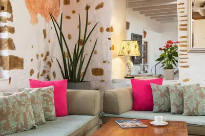 a living room with a couch and pink pillows at Villa Splantzia - Heated pool - Garden in Chania Town