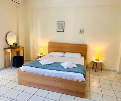 a bedroom with a bed with two pillows on it at Kd's apartment B in Chania Town