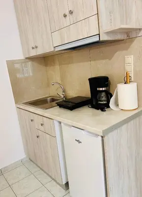 a kitchen counter with a sink and a microwave at Kd's apartment B in Chania Town