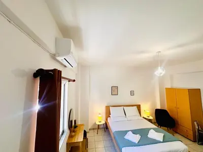 a small bedroom with a bed and a window at Kd's apartment B in Chania Town