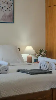 a bedroom with a bed with towels on it at Melina's House in Chania Town
