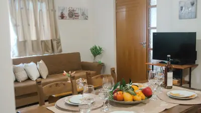 a living room with a table with a bowl of fruit at Melina's House in Chania Town