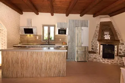 a kitchen with a sink and a stove at Beautiful Villa in Zounákion