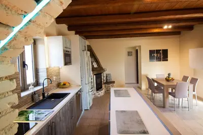 a kitchen with a table and a dining room at Beautiful Villa in Zounákion