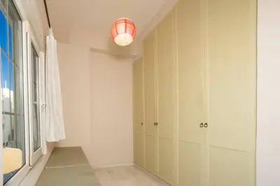 a hallway with white cabinets and a light fixture at The White Marble Luxury City Apt in Chania Town
