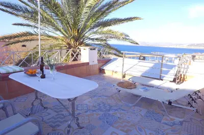 a balcony with two tables and a view of the ocean at Venetian House in Chania Town