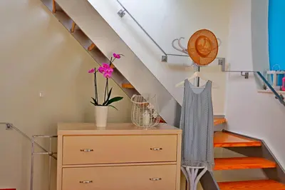 a room with a dresser and a staircase at Venetian House in Chania Town