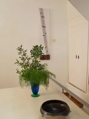 a vase sitting on a table with a plant in it at Venetian House in Chania Town