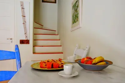a table with a bowl of fruit and a plate of fruit at Venetian House in Chania Town