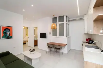 a kitchen and living room with a couch and a table at Alma & Nina Apt in Chania Town
