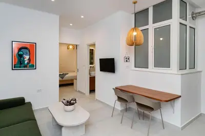 a kitchen and living room with a table and a couch at Alma & Nina Apt in Chania Town