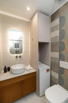 a bathroom with a sink and a toilet and a mirror at Alma & Nina Apt in Chania Town