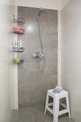 a shower with a white stool in a bathroom at Campagna Mare in Kissamos