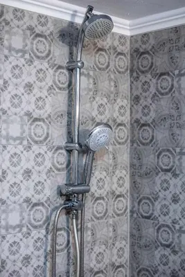 a shower with a shower head in a bathroom at Kamari Petit Studio & Apartment - Chania in Chania Town