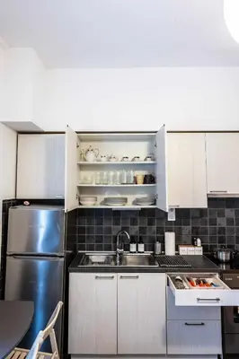 a kitchen with a sink and a refrigerator at Kamari Petit Studio & Apartment - Chania in Chania Town