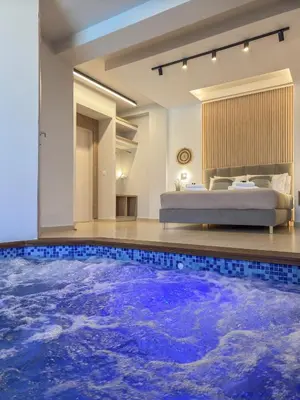 a bedroom with a large pool in the middle of a room at Olive Chrysi Luxury Villa with in-room plunge pool in Chania Town
