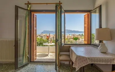 a bedroom with a bed and a window with a view at Three Bedroom Apartment in City Center with Sea View near the Beach in Kissamos