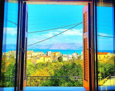 a view of a city from a window at Three Bedroom Apartment in City Center with Sea View near the Beach in Kissamos