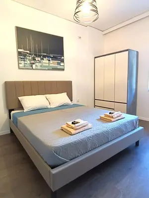 a bedroom with a bed with two towels on it at Casa Dina Nea Chora in Chania Town