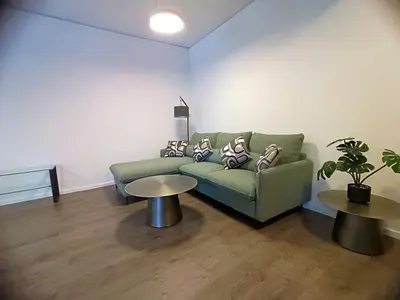 a living room with a green couch and two tables at Casa Dina Nea Chora in Chania Town