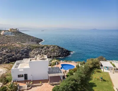 an aerial view of a house and the ocean at Tersanas Sea Front Villas in Tersanas