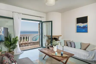 a living room with a couch and a table at Tersanas Sea Front Villas in Tersanas