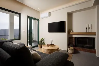 a living room with a couch and a fireplace at Elirion Luxury Home II in Kamária