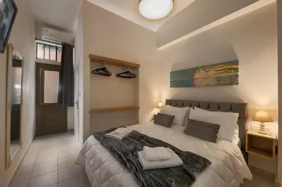 a bedroom with a large bed in a room at Elartis Apartment in Chania Town