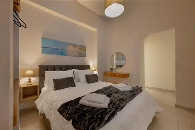 a bedroom with a large bed with two towels on it at Elartis Apartment in Chania Town