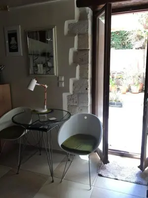 a table and chairs in a room with a window at Casa Argirenia - Venetian Mansion in Old Harbour in Chania Town